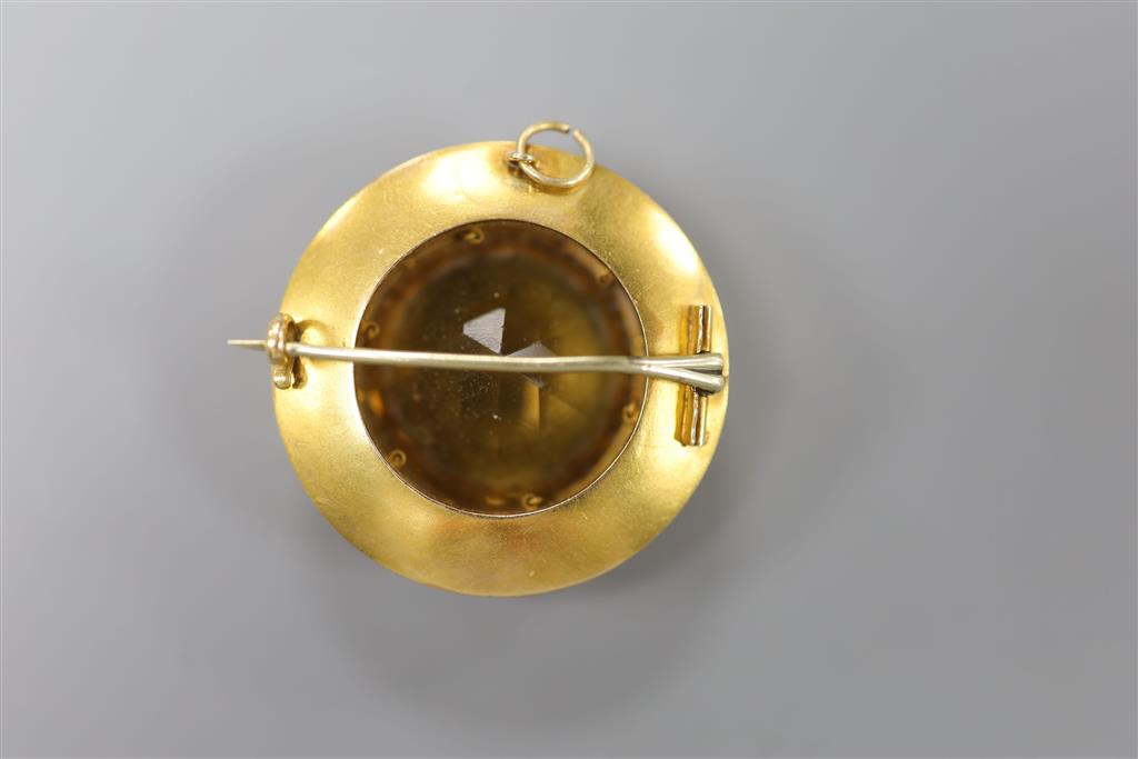 A Victorian yellow metal, citrine(chipped) and white enamel set target pendant brooch, 37mm, gross 16.6 grams (enamel a.f.).
